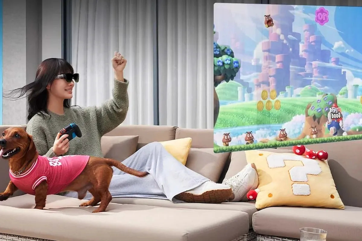 A gamer using AR glasses and a controller while relaxing on a sofa.