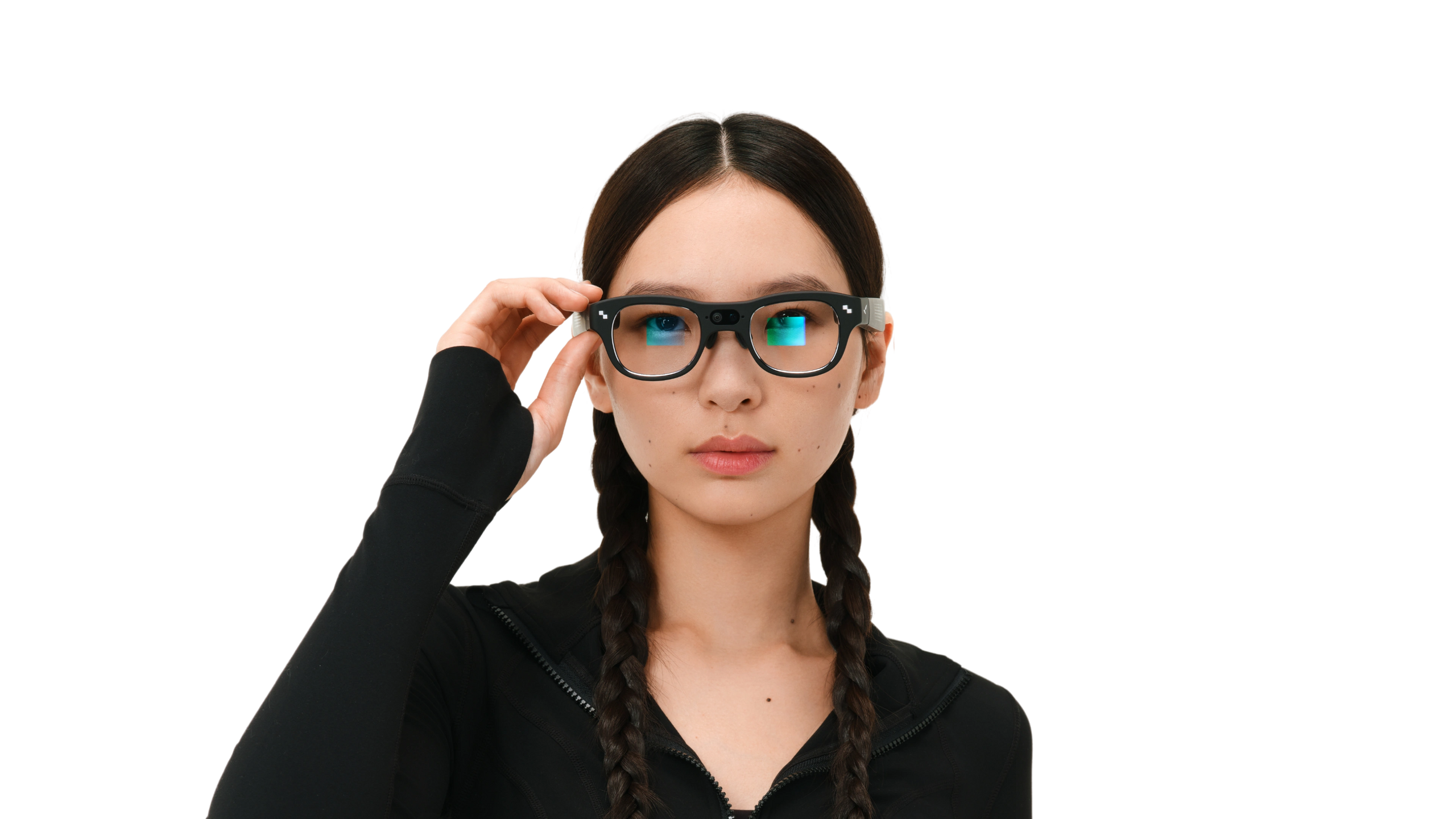 Close-up of a woman touching the temple of RayNeo X3 Pro glasses, with a colorful display glowing in the lenses against a dark background.